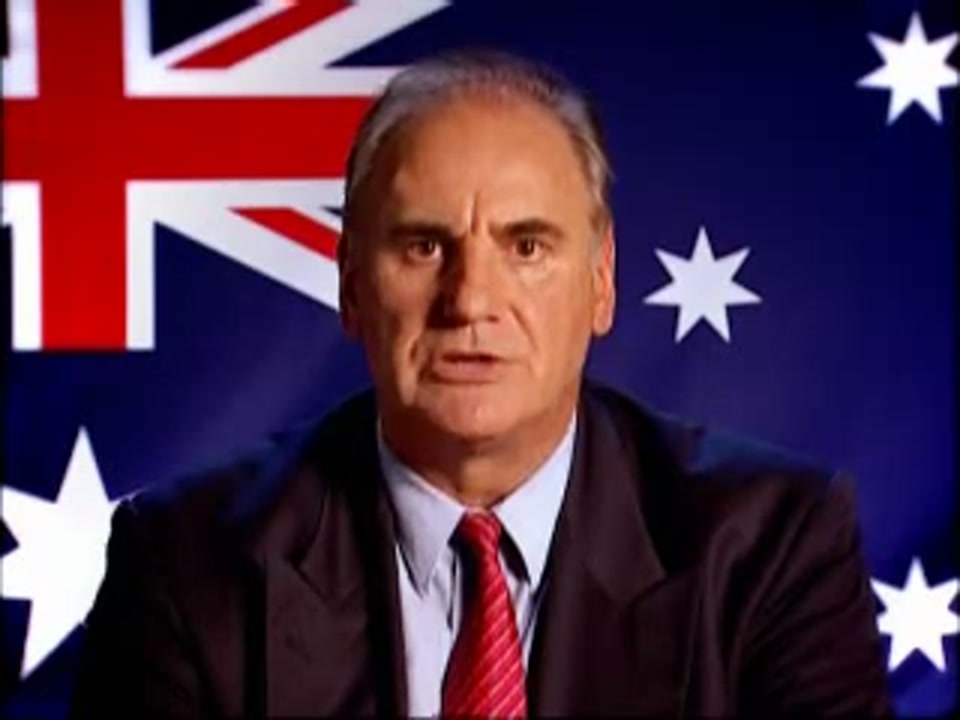 Un-Australianism (2005), scene 3 at 01:01: Kekovich leans forward slightly, adopting an even more earnest and solemn tone, as if imparting a sacred truth.
