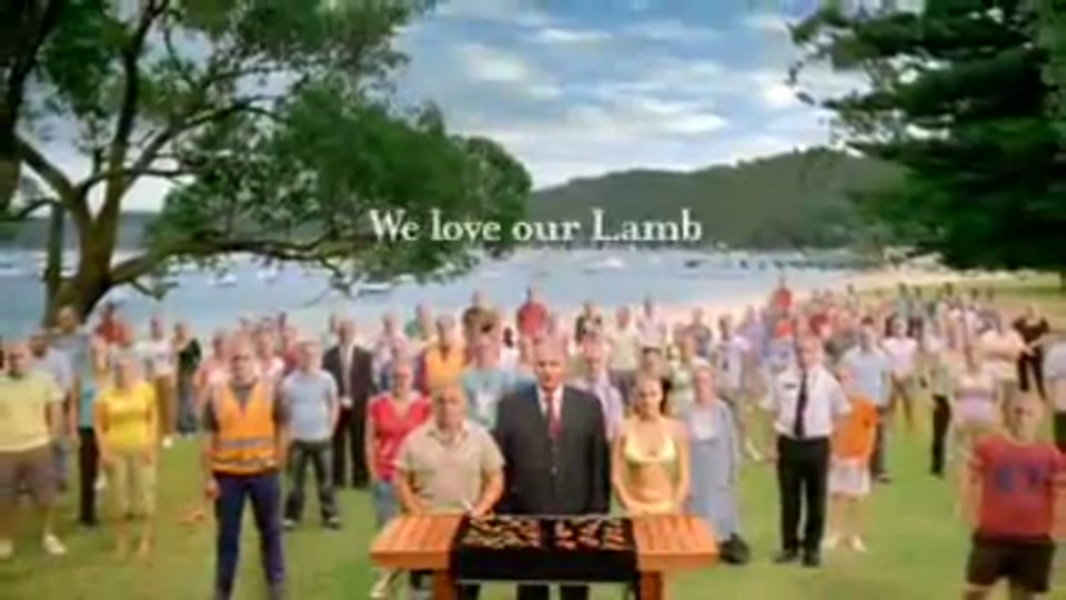 Address to the Nation (GFC Rally) (2009), scene 5 at 01:25: The scene cuts to a vast rally on a grassy area by a beach, with a large bay filled with boats in the background. The speaker stands at a lectern which is actually a barbecue laden with lamb chops.
