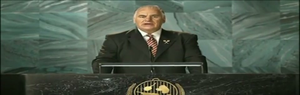 Sam Kekovich UN Speech (2010), scene 5 at 01:13: Kekovich's speech reaches its crescendo. The music swells with patriotic fervor. He speaks with utmost seriousness, as if expecting a Nobel Prize.