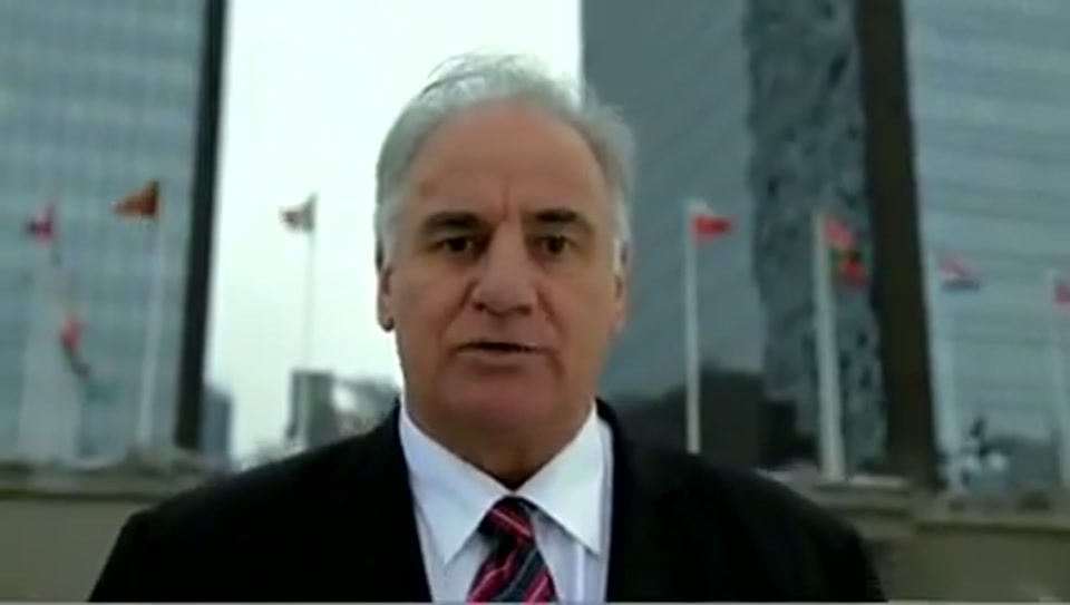 Address to the United Nations of Australia (2011), scene 5 at 01:01: Kekovich stands on the Spanish Steps in Rome. A montage follows: he poses with an attractive woman on a Lambretta scooter, is served Lambrusco wine in a restaurant, and sits in a silver Lamborghini.