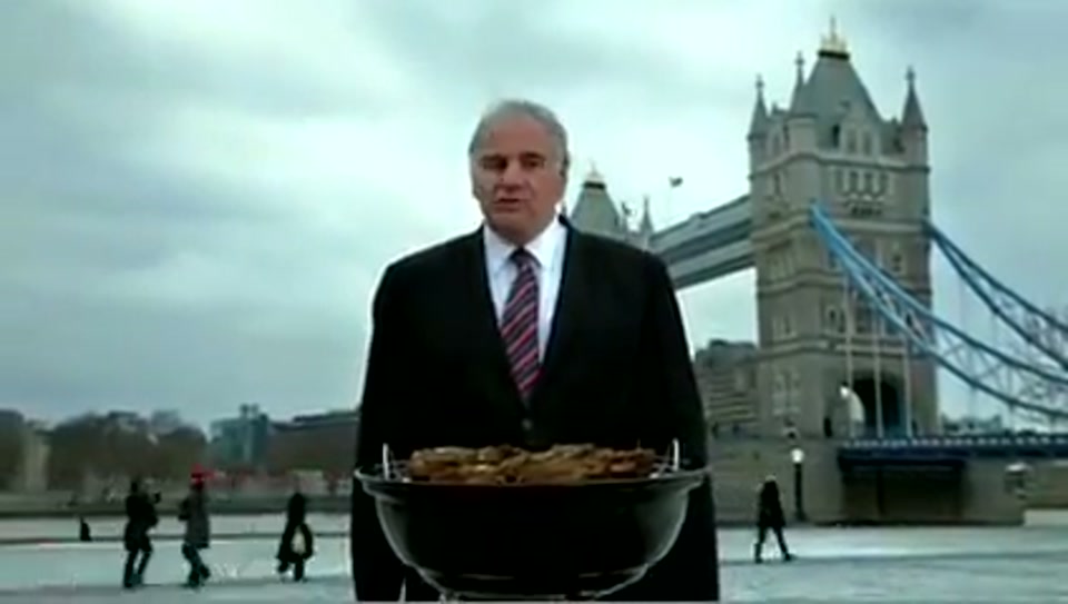 Address to the United Nations of Australia (2011), scene 6 at 01:15: Kekovich stands on a dramatic, windswept beach. A barbecue grill (a Weber kettle) is set alight on the beach.
