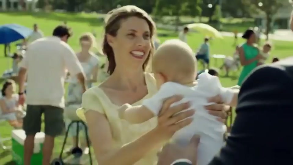 Generation Lamb (2014), scene 5 at 00:48: Kekovich walks solemnly through two lines of parents and children standing in a park, all attending to their barbecues. The scene has the feel of a guard of honour.