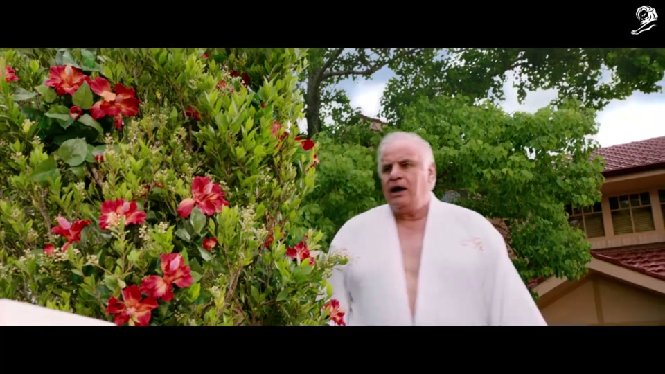Lamb Side Story (2018), scene 5 at 01:42: A man in a business suit sits on a white picket fence, attempting to remain neutral. As the gangs march past, he is sprayed with a hose by an older man in a bathrobe (Sam Kekovich) and knocked off the fence.