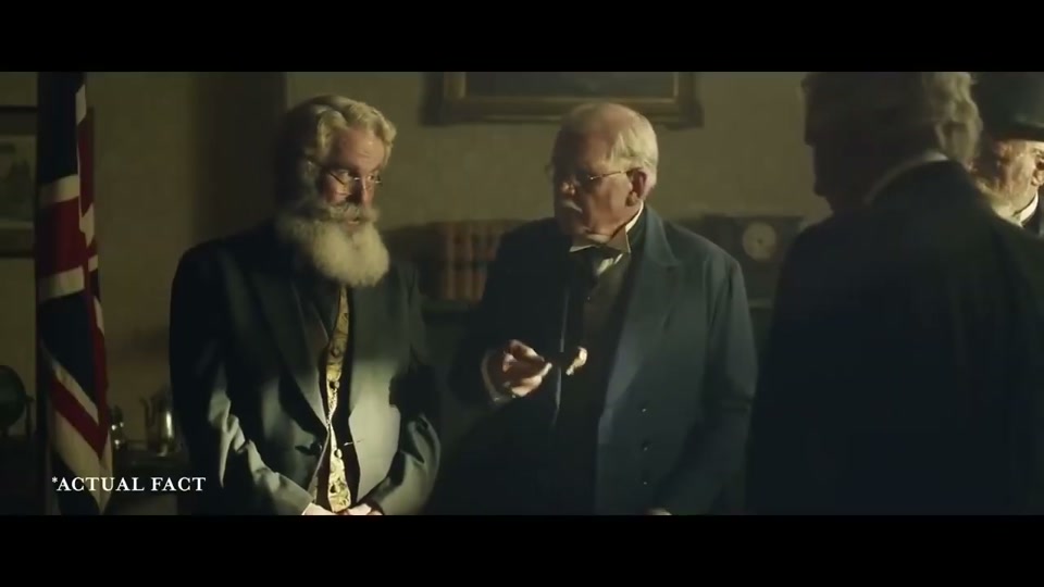 Unite Australia and New Zealand (2019), scene 1 at 00:09: A dimly lit, smoky room in a historical setting. Several men in early 20th-century suits are gathered around a large table.