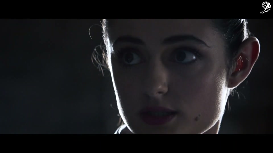 Lambalytica (2020), scene 2 at 00:23: Inside the dark, server-filled headquarters of "Lambalytica," agents monitor screens showing data maps of Australia and CCTV feeds. A stern female executive explains the operation to a new recruit.