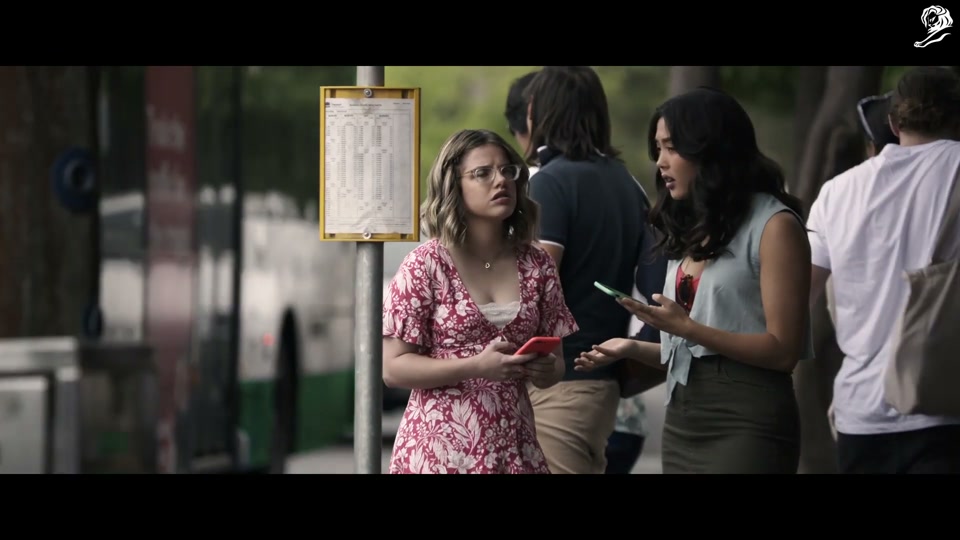 Lambalytica (2020), scene 4 at 01:00: In Perth, two young women at a bus stop are on their phones. One is about to "like" a social cause post when her phone is hacked by Lambalytica.