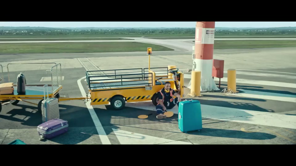The Lost Country of the Pacific (2022), scene 1 at 00:03: An empty, sterile airport terminal. A sign reads "GATES CLOSED". A lone baggage handler idly mops the floor. On the tarmac, another bored baggage handler sits against a tug, playing paddle ball.