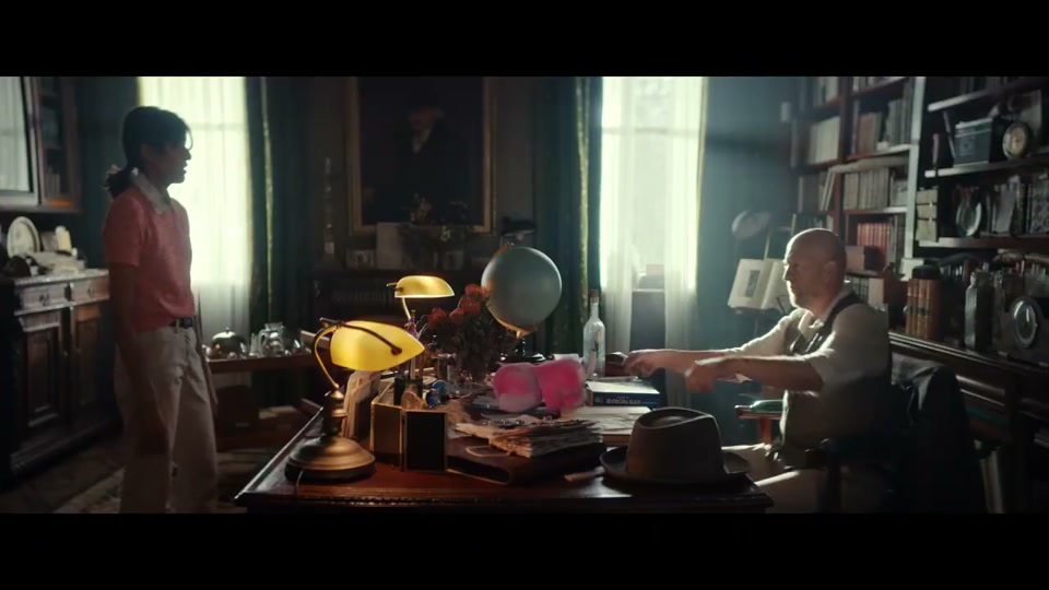 The Lost Country of the Pacific (2022), scene 2 at 00:37: A young woman runs frantically across a university campus and into a building labelled "FACULTY OF INTERNATIONAL STUDIES". She bursts into a professor's dusty, book-lined office.