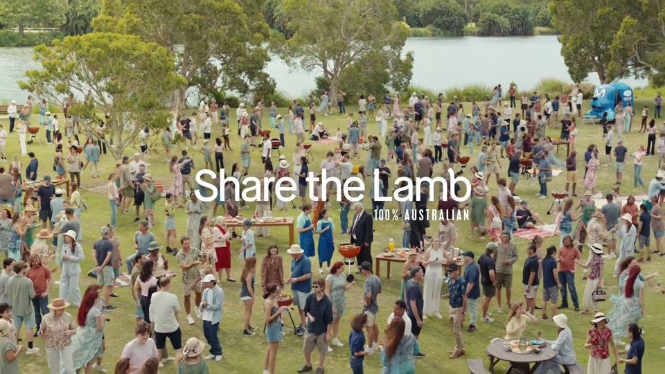 The Comments Section (2025), scene 7 at 03:06: The entire crowd joyfully streams out of the stadium grandstand and into the sunny park from the beginning of the ad. A massive, happy barbecue is underway.
